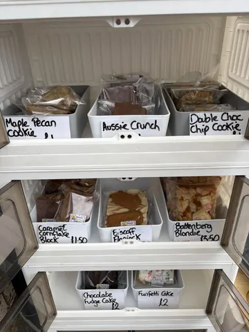 A white shelf with a variety of food items on it.