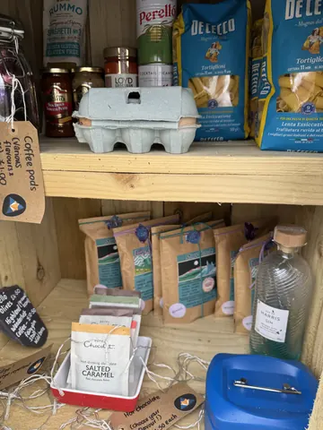 A wooden shelf with various items on it.