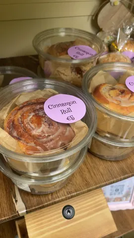 A glass container with a cinnamon roll in it.