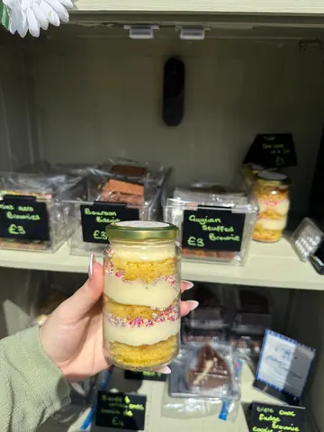 A jar of cake with sprinkles in it.