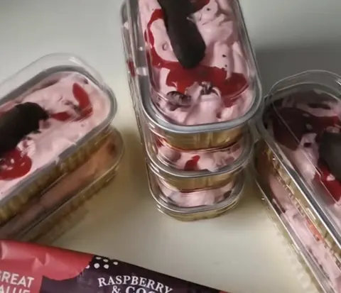 A box of raspberry and cream desserts.