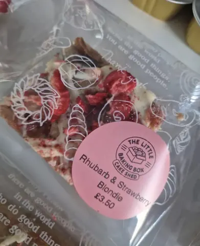 A bag of food with a pink label.