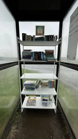 A bookshelf with books and magazines on it.