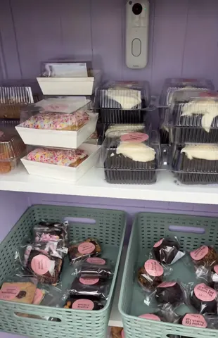 A display of various desserts in plastic containers.