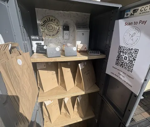 A small wooden shelf with a sign on it.