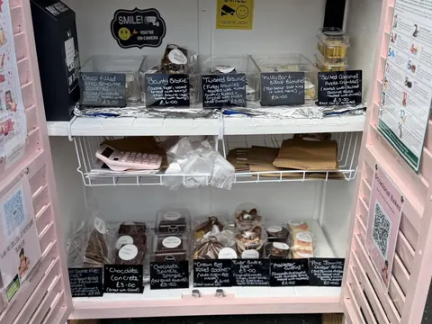 A display case with a variety of food items in it.