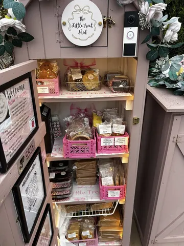 A pink display case with a sign that says Welcome.