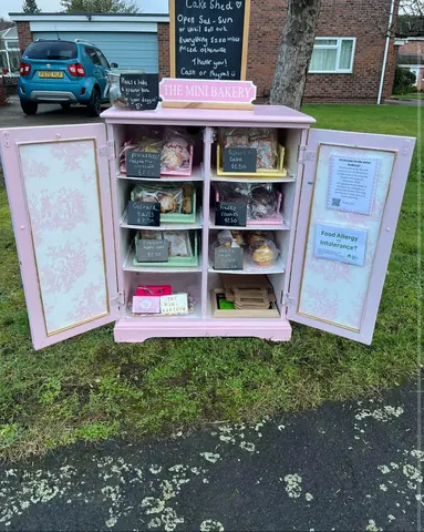 A pink cabinet with a chalkboard sign on it.