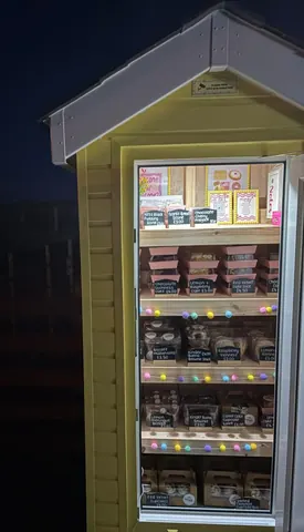 A yellow building with a refrigerator inside.
