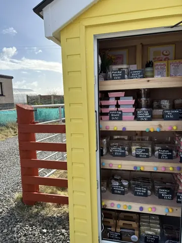 A yellow building with a sign that says "sale".