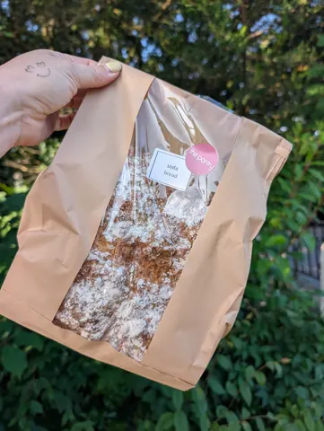 A bag of food is being held by a person.