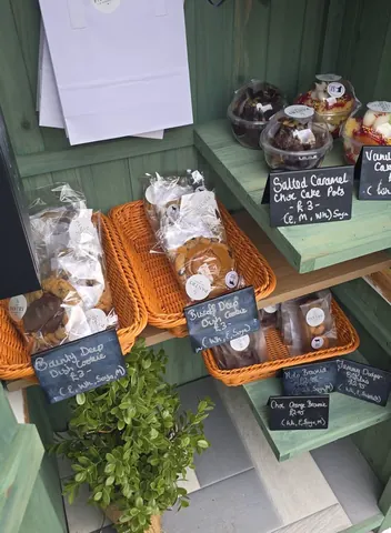 A display of various baked goods, including cookies and cakes, is visible in the image.
