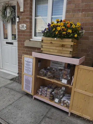 A wooden box with a sign that says "Intolerance?" on it.