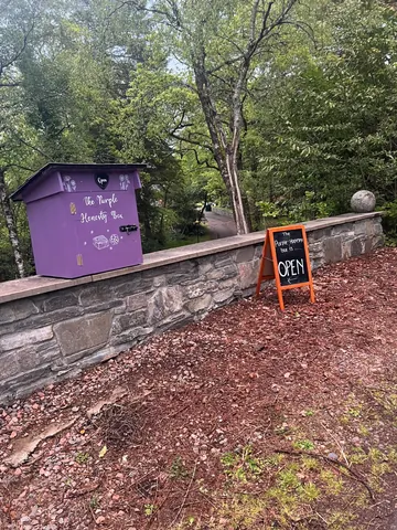 A purple box with a sign on it.