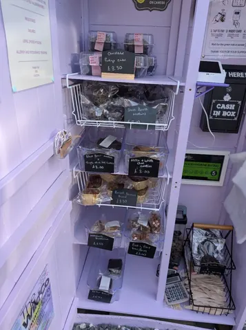 A purple room with a shelf full of food.