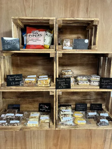 A wooden shelf with a variety of food items on it.