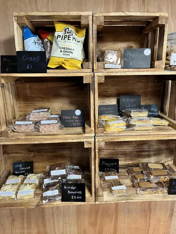A shelf with a variety of snacks and chips on it.