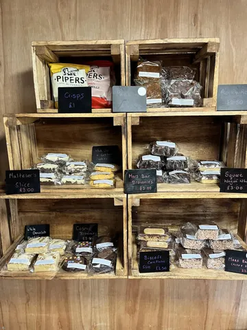 A wooden shelf with a variety of food items on it.