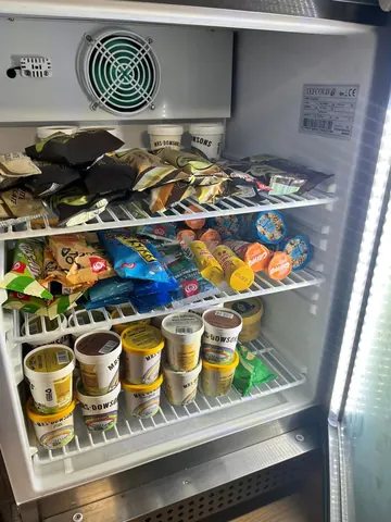 A refrigerator with a lot of food in it.
