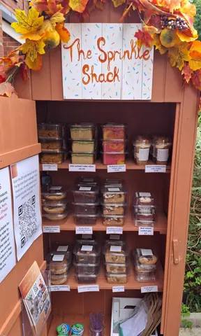 A wooden shack with a sign that says "Shack" on it.