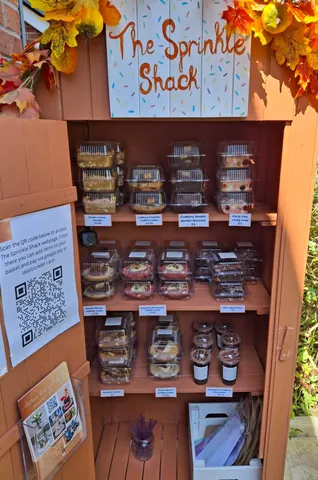 A wooden shelf with a sign that says "scan to pay" on it.