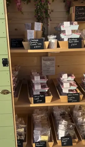 A wooden shelf with a sign that says "allergen" on it.