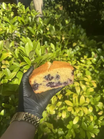 A person is holding a piece of cake.