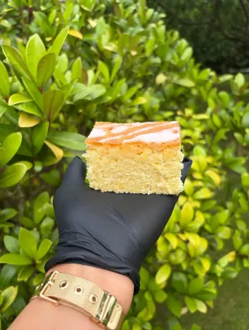 A person is holding a piece of cake.