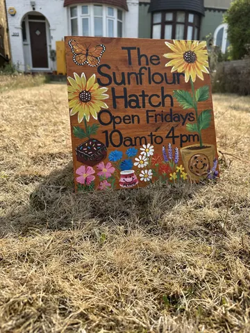 A sign is posted in the grass.