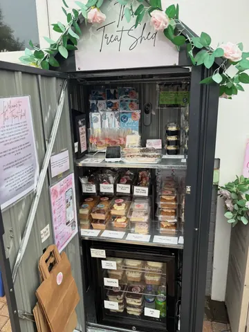 A display case with a variety of pastries and desserts.