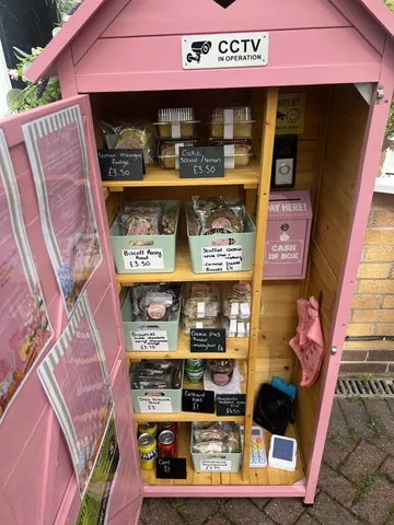 A pink box with a sign that says "Pay Here!"