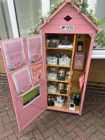 A pink building with a sign that says "CCTV" on it.