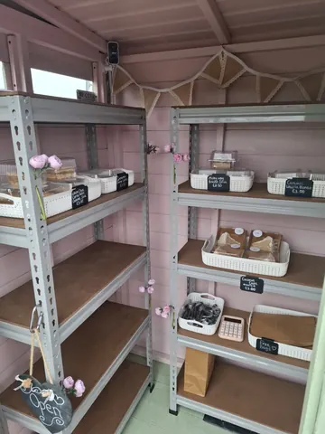 A pink room with shelves full of food.
