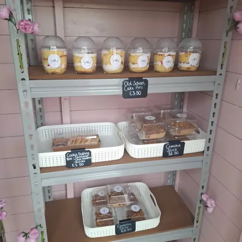 A display case with a variety of desserts and pastries.