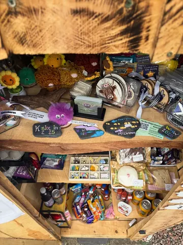 A wooden shelf with various items on it.