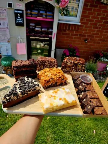 A tray of various desserts is displayed on a table.