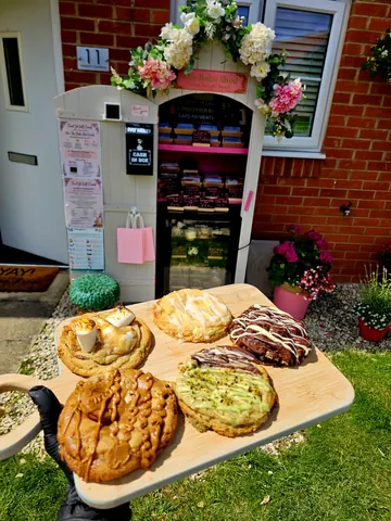 A wooden tray with a variety of pastries on it.