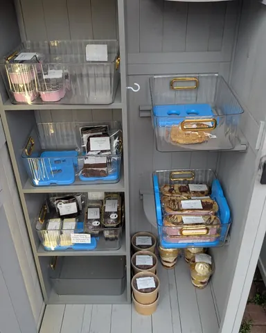 A blue shelf with food items in it.