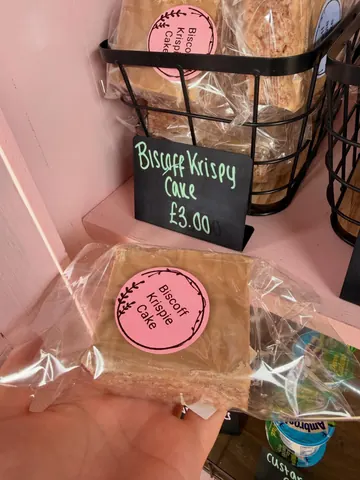 A person is holding a biscuit cake.