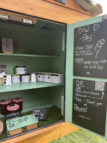 A green box with a sign that says "how to buy".