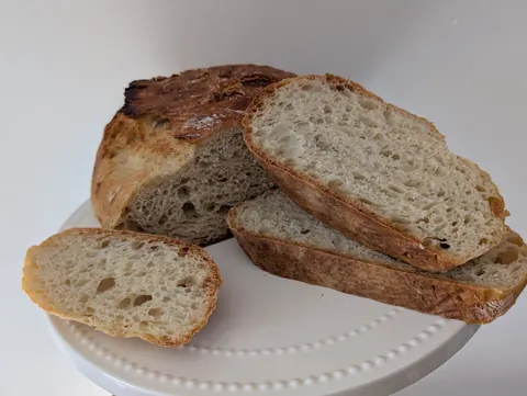 A white plate with a loaf of bread on it.