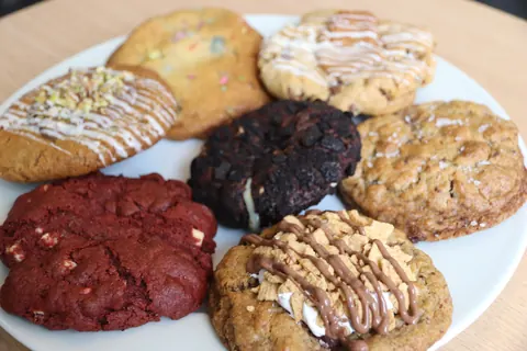 A plate of cookies with various flavors and toppings.