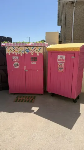 Two pink storage units are parked next to each other.