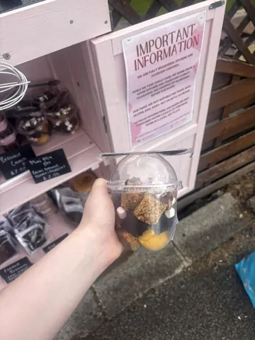 A person is holding a container with food in it.