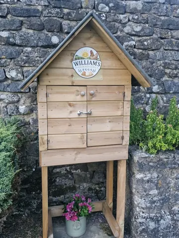 A small wooden building with a sign on it.
