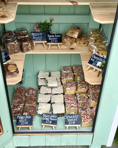 A display case with a variety of pastries and desserts.