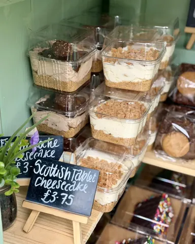 A display of various desserts in plastic containers.